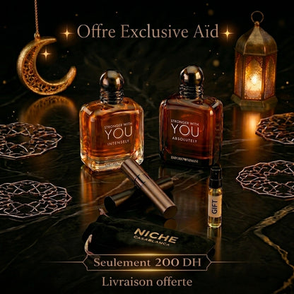 Two perfume bottles labeled 'Stronger with You' on a dark surface with decorative elements.